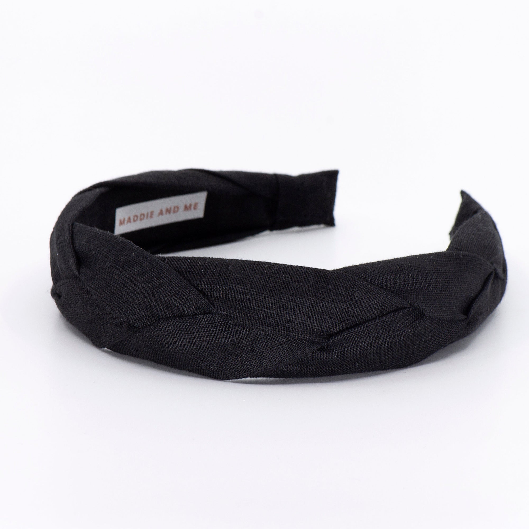 black braided headband on a white background