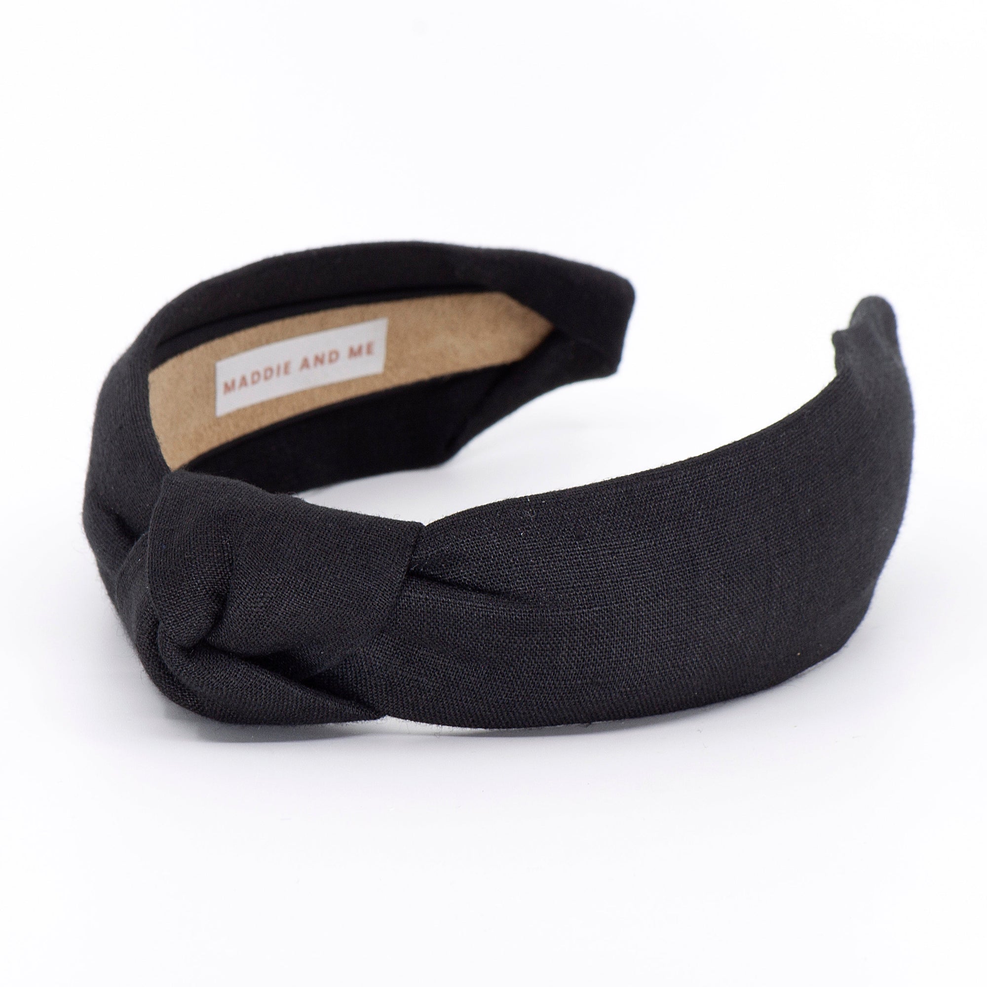 black knotted linen headband on a white background