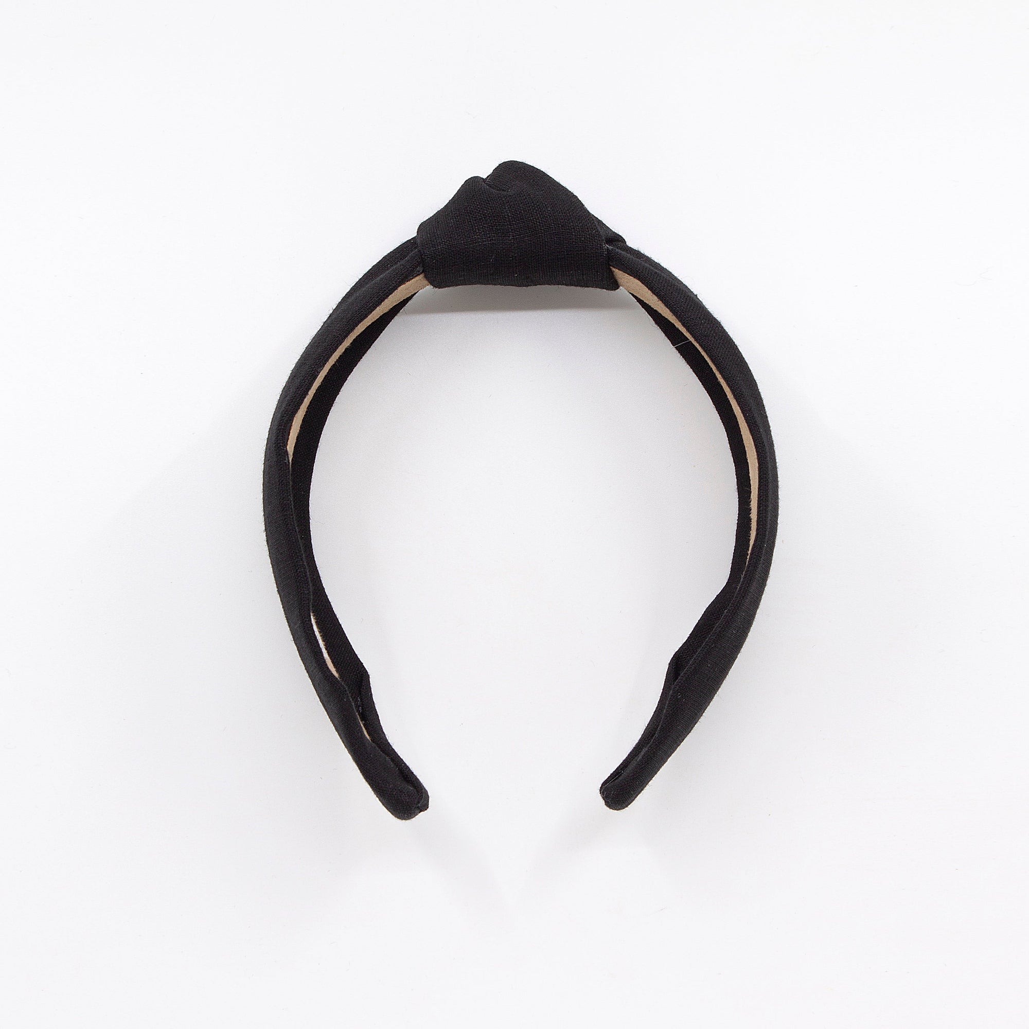black knotted linen headband on a white background