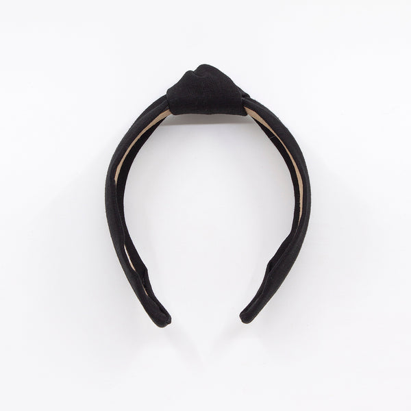 black knotted linen headband on a white background