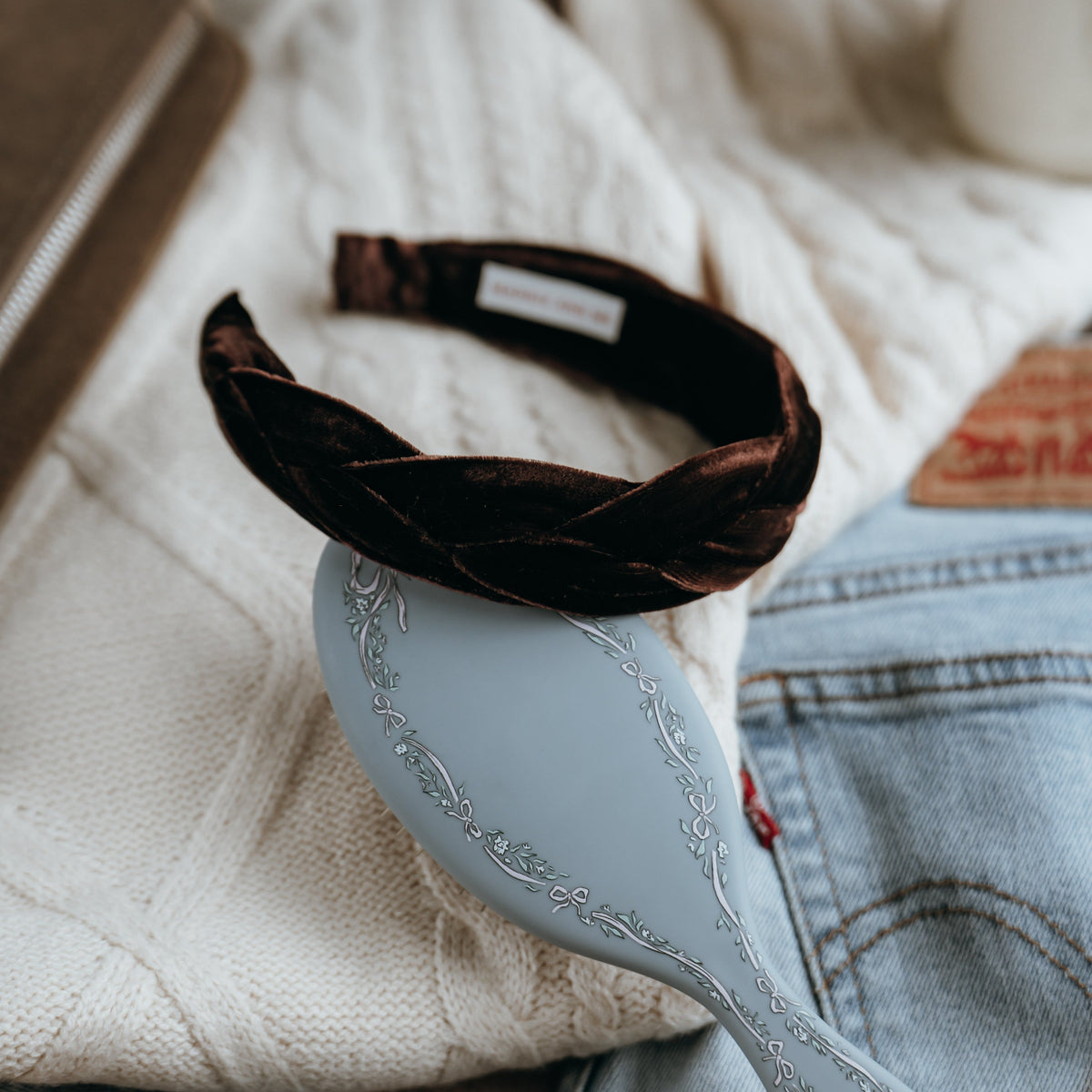 Decorative spoon with a woven handle on a textured surface