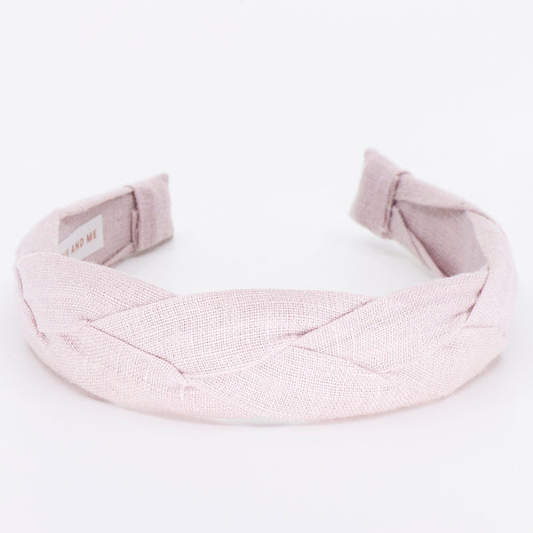 light pink braided headband on a white background