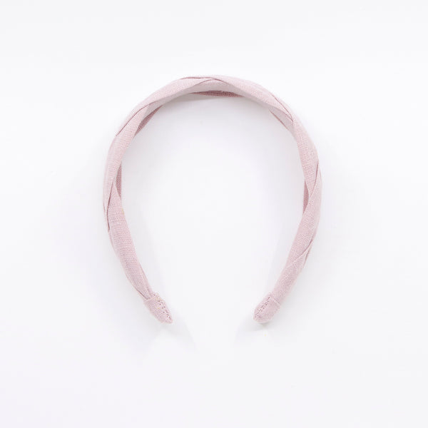 light pink braided headband on a white background
