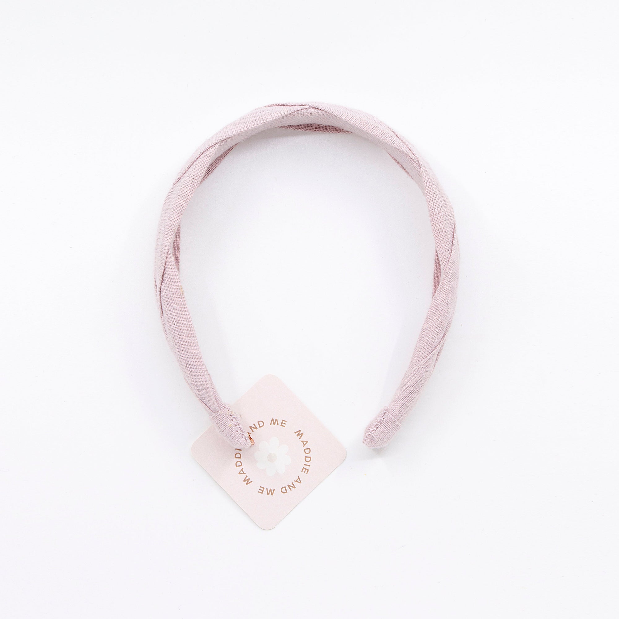 light pink braided headband on a white background with tag