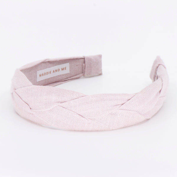 light pink braided headband on a white background