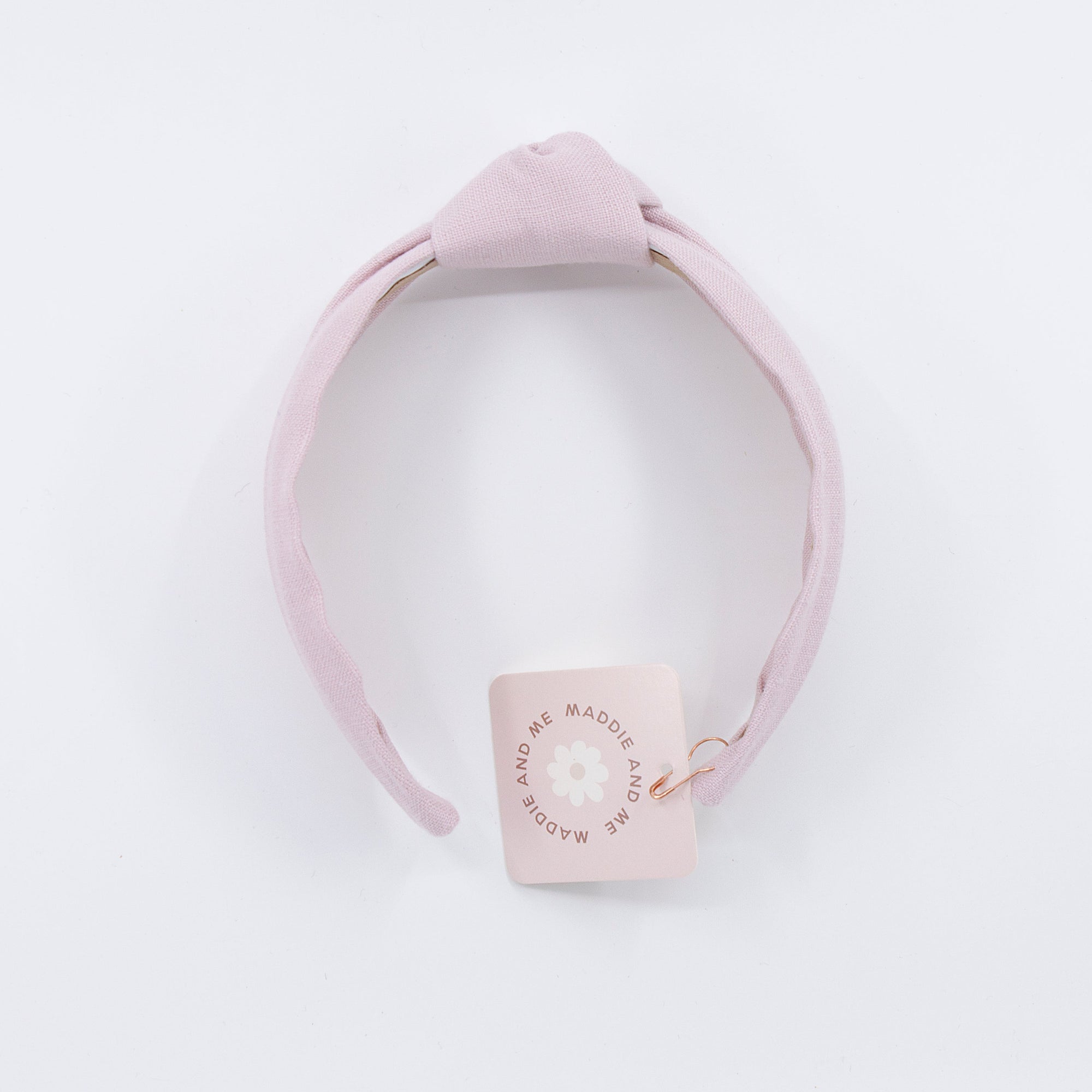 light pink linen knotted headband on a white background