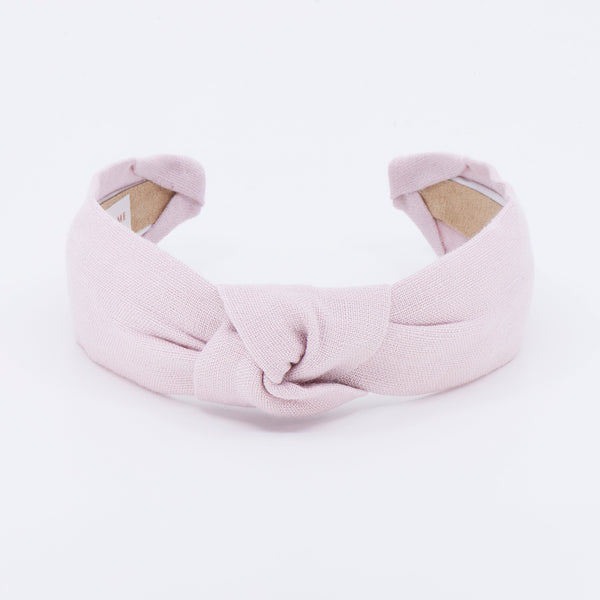 light pink linen knotted headband on a white background