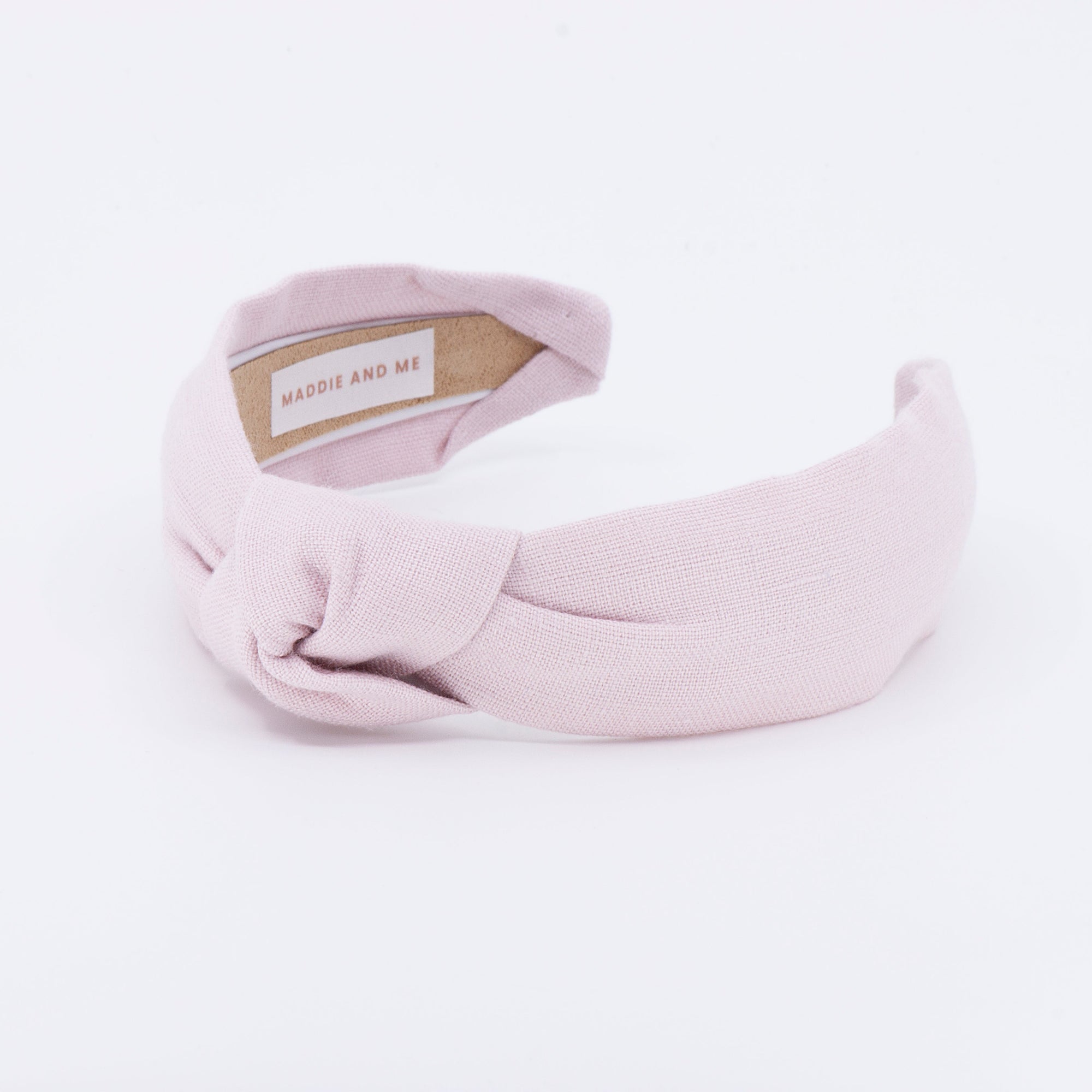 light pink linen knotted headband on a white background