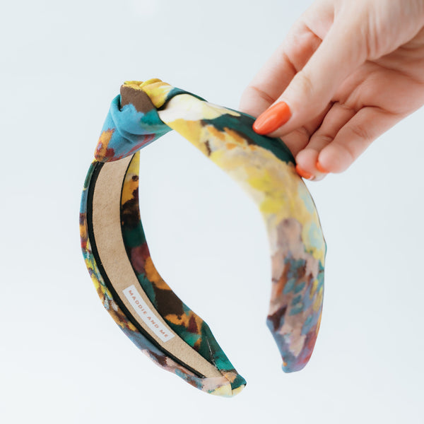 multicolor floral knotted headband on a white background