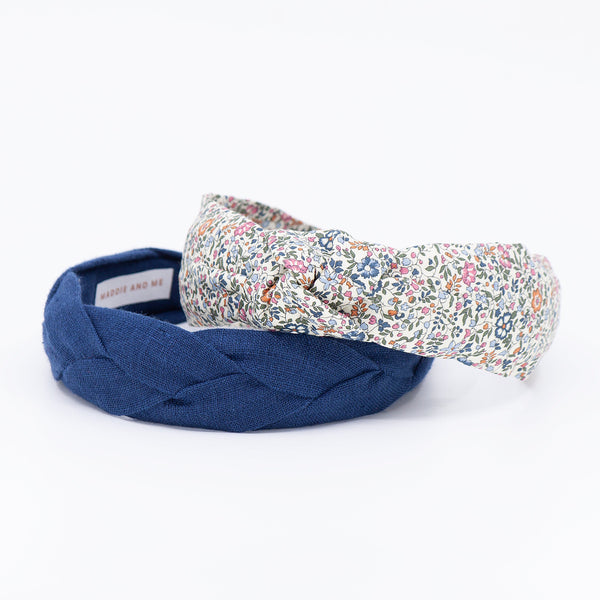 navy braided and floral headband on a white background