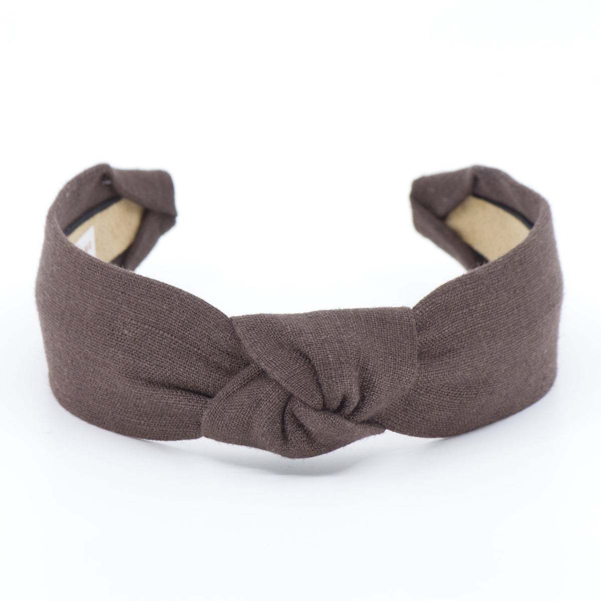 A fabric headband with a twisted knot in the center, shown on a plain white background. The headband is a dark brown color, and the inner lining is a light beige.