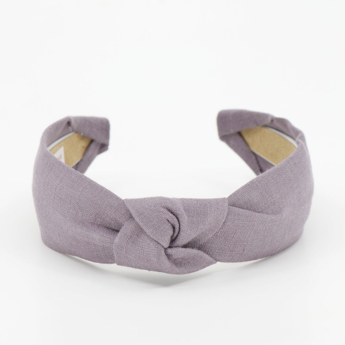 A dusty purple fabric headband with a central knot detail, displayed on a clean white background.