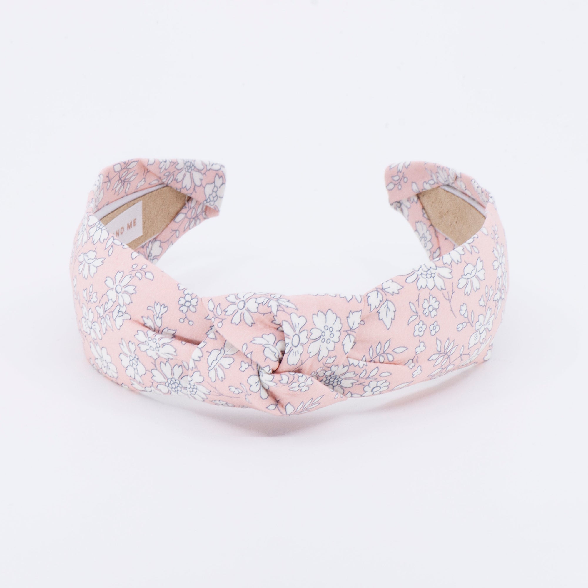peach floral patterned headband on a white background