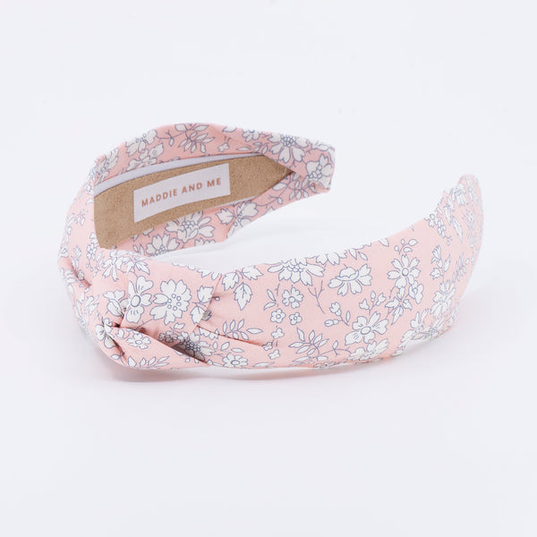 peach floral patterned headband on a white background