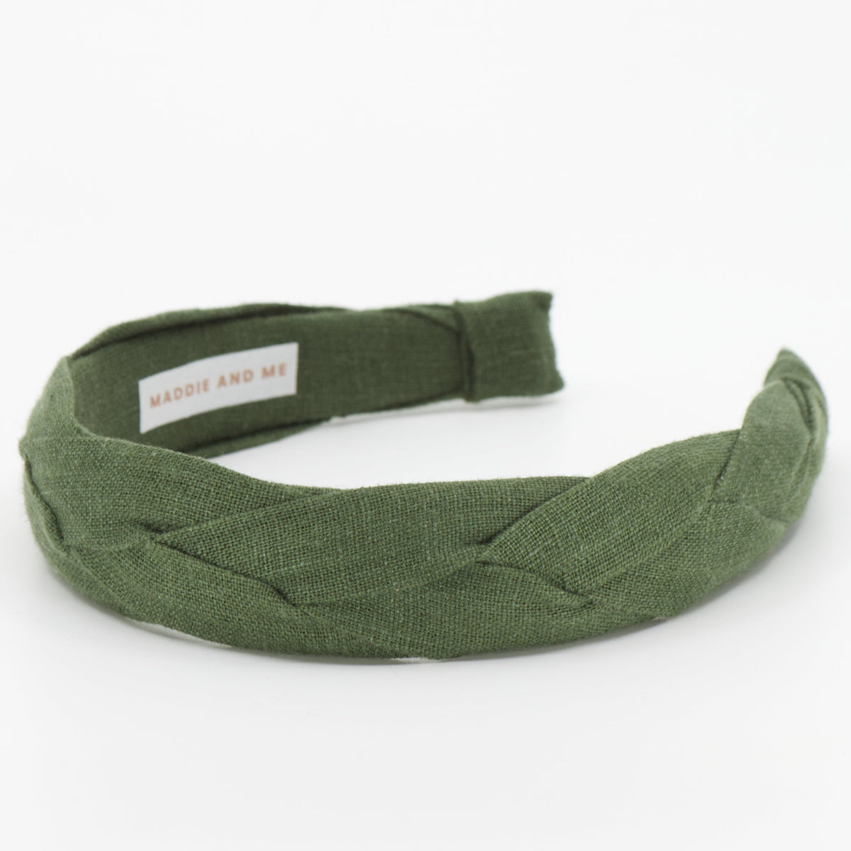 Pine green braided headband made with European linen on a white background with MADDIE AND ME tag.