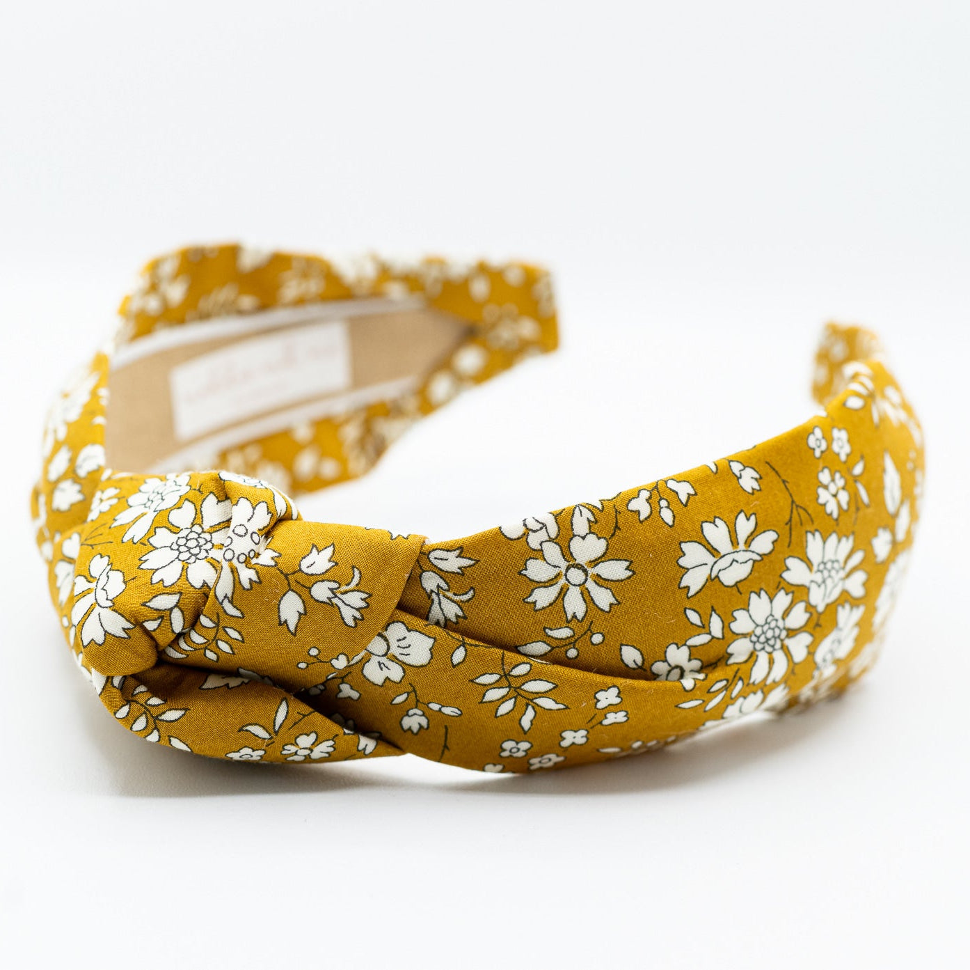 mustard floral headband on a white background